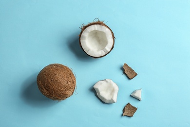 Flat lay composition with coconuts on color background