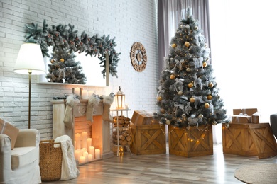 Stylish interior with decorated Christmas tree in living room