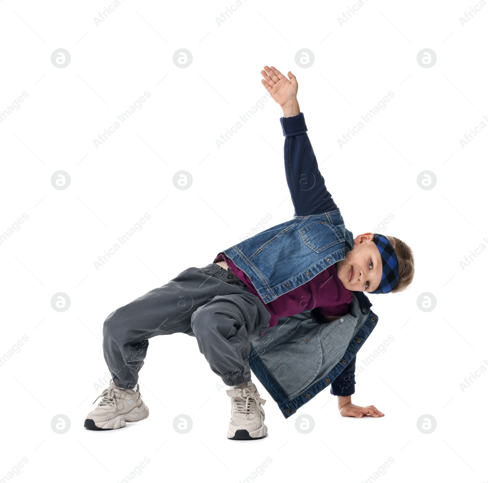 Photo of Happy little boy dancing on white background