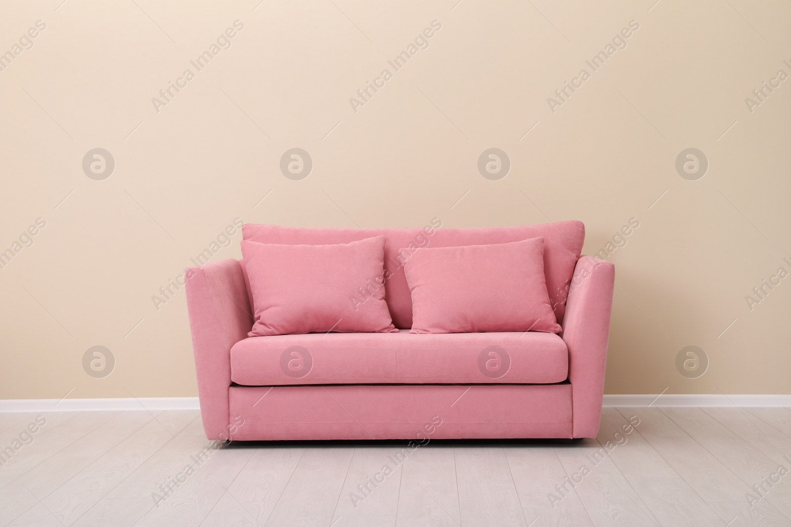 Photo of Room interior with comfortable sofa near color wall