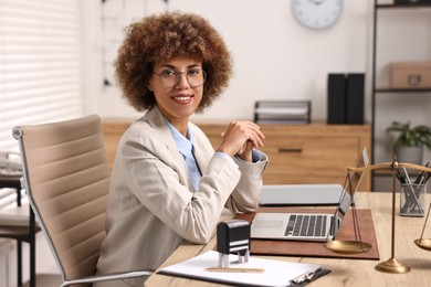 Photo of Notary in glasses at workplace in office