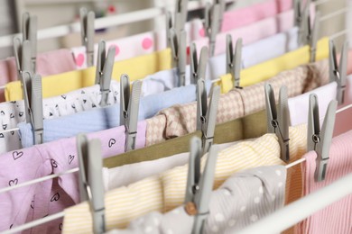 Clean laundry hanging on drying rack, closeup