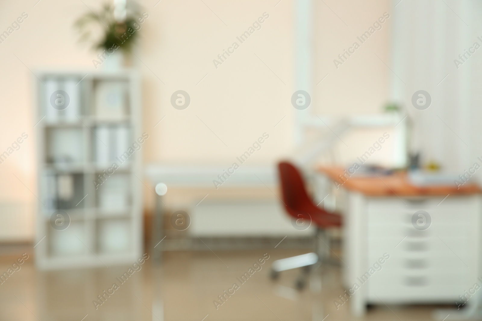 Photo of Blurred view of doctor's office interior with workplace