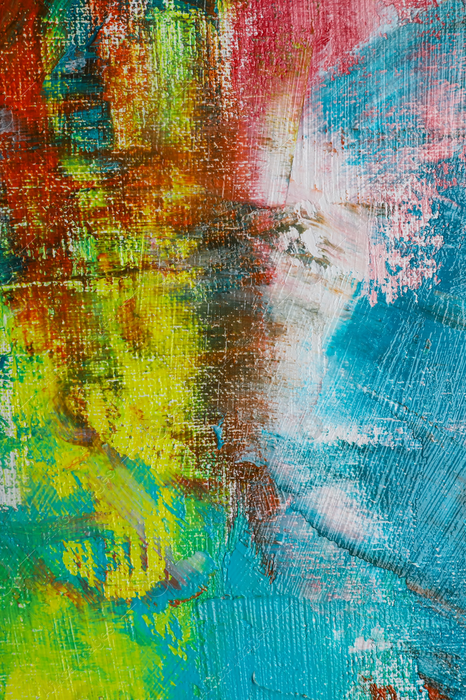 Photo of Strokes of colorful acrylic paints on canvas, closeup