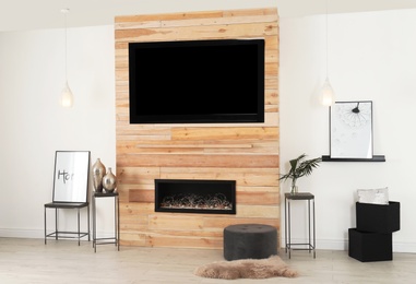 Living room interior with decorative fireplace in wooden wall