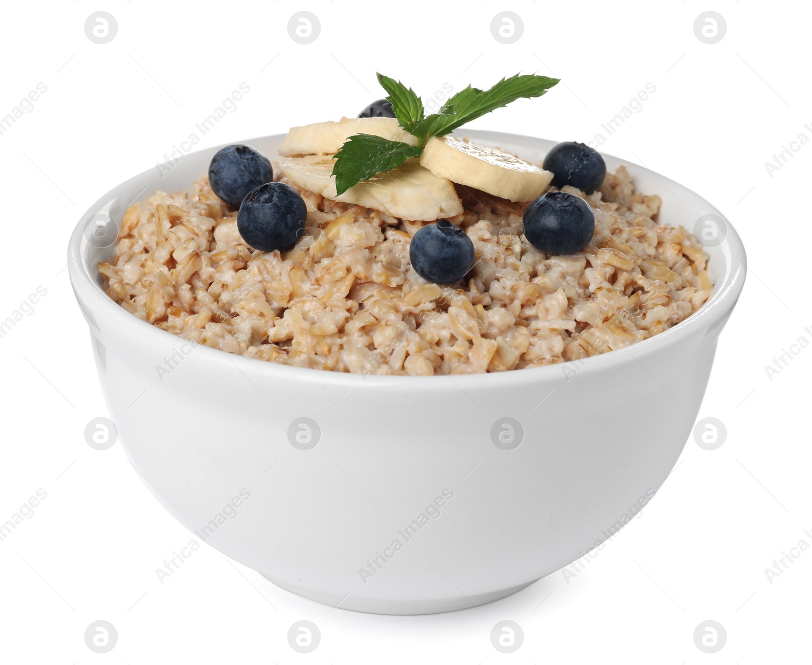 Photo of Tasty boiled oatmeal with blueberries and banana in bowl isolated on white