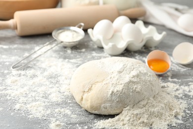 Wheat dough and products on grey table. Cooking pastries