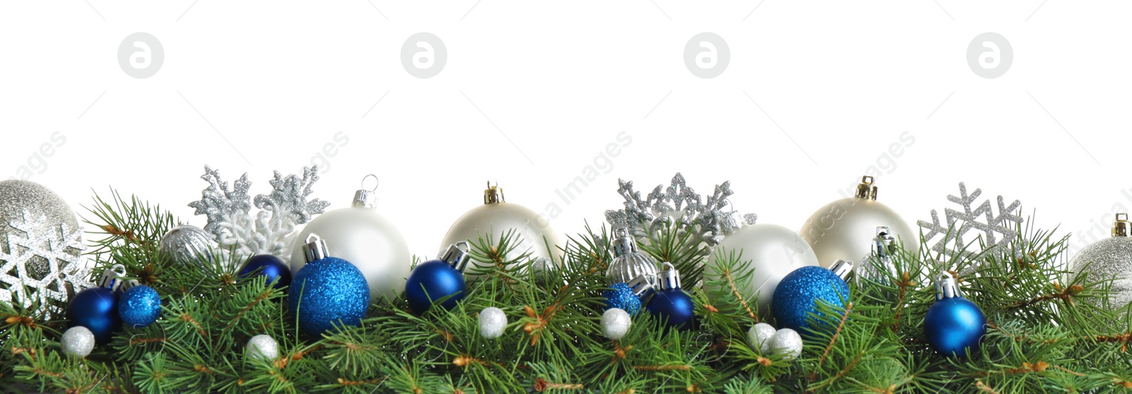 Photo of Fir tree branches with Christmas decoration on white background