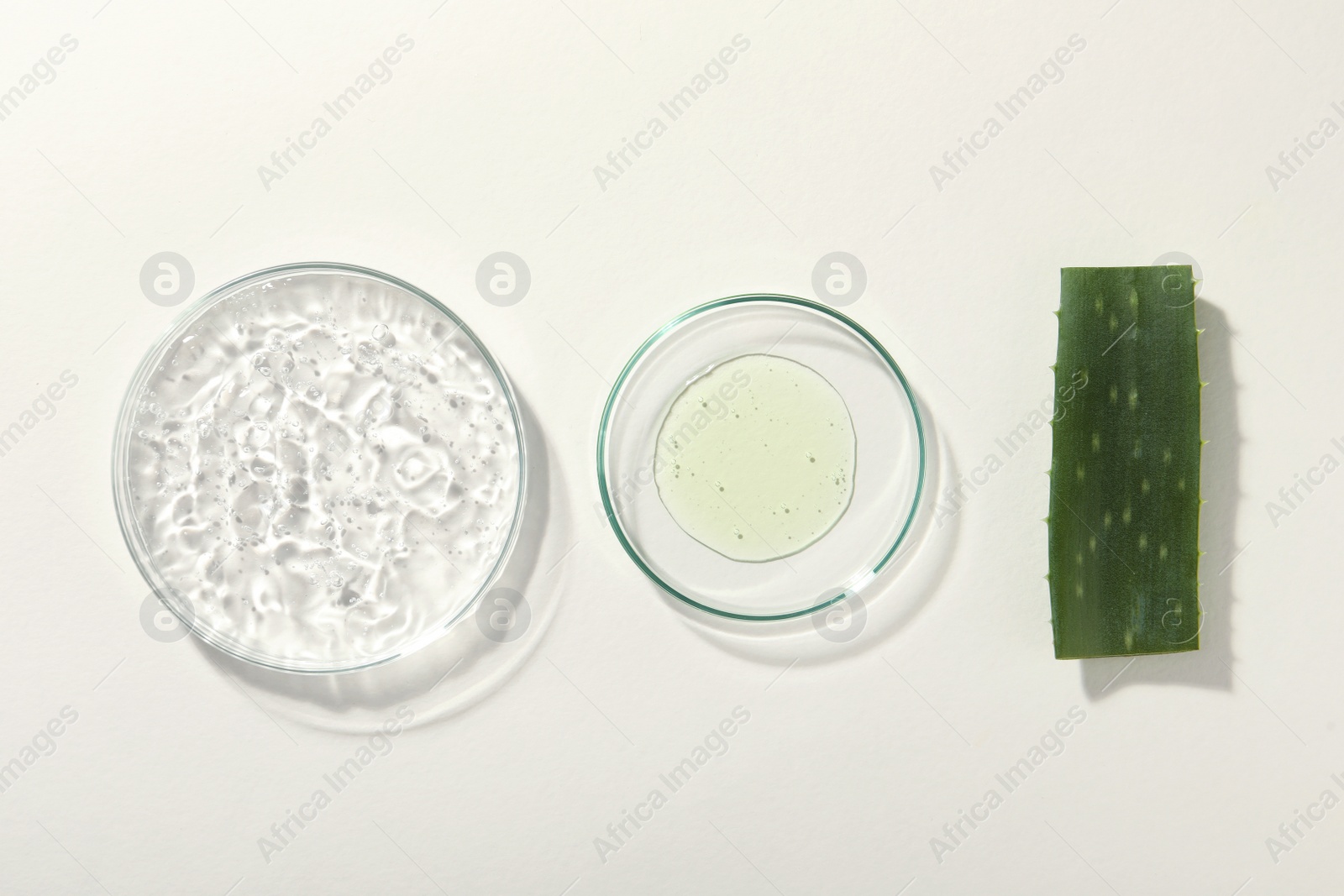 Photo of Flat lay composition with cosmetic gel and aloe on white background