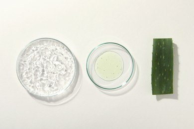 Photo of Flat lay composition with cosmetic gel and aloe on white background