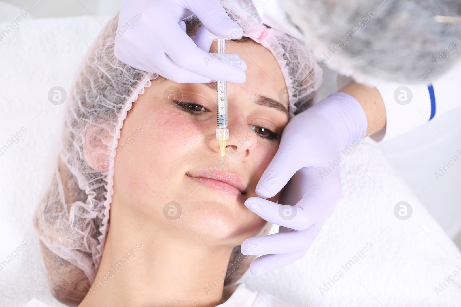 Photo of Woman undergoing face biorevitalization procedure in salon, closeup. Cosmetic treatment