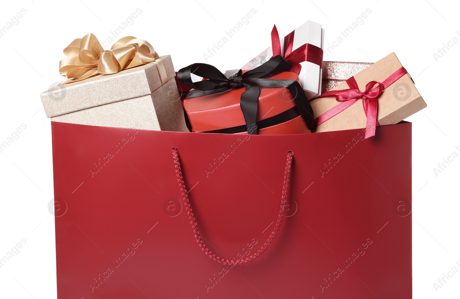 Photo of Dark red paper shopping bag full of gift boxes on white background, closeup