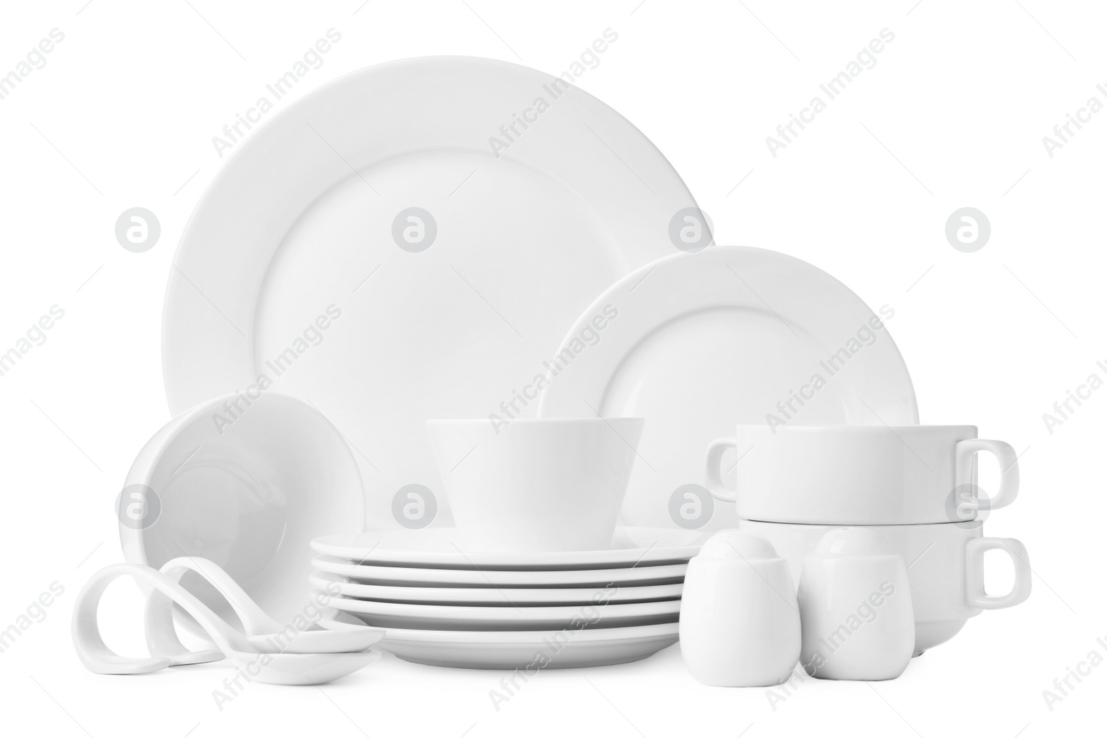 Photo of Set of clean dishware isolated on white