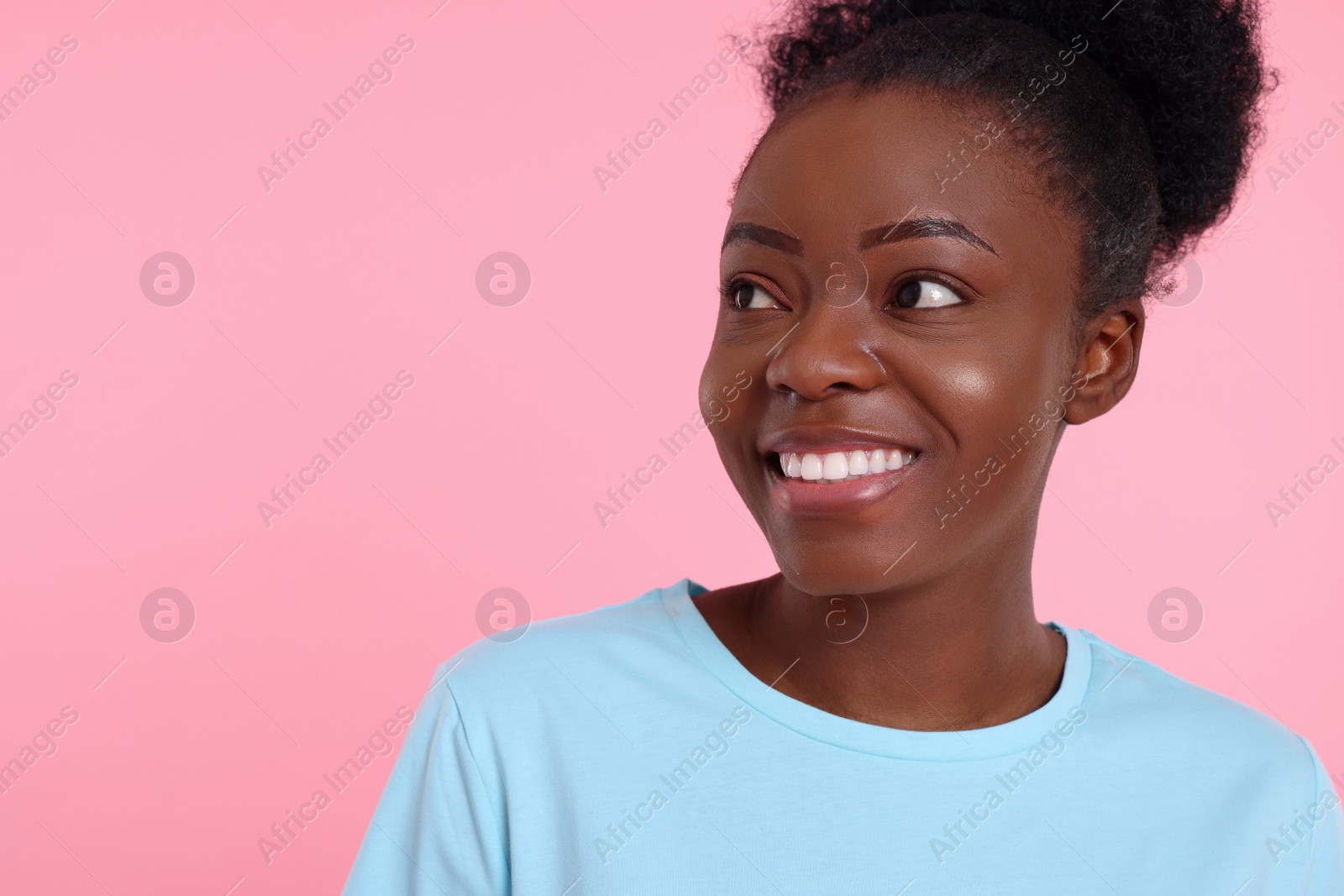 Photo of Portrait of happy young woman on pink background. Space for text