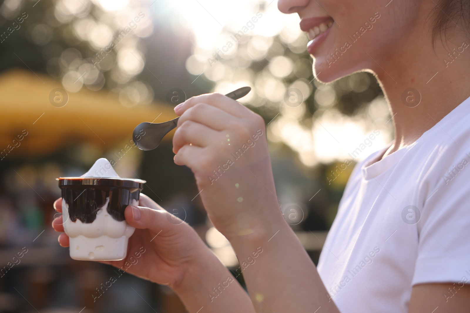 Photo of Lviv, Ukraine - September 26, 2023: Woman with McDonald's ice cream outdoors, closeup