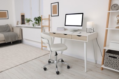 Workplace with comfortable office chair indoors. Interior design