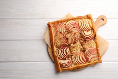 Tasty fresh apple galette on white wooden table, top view. Space for text