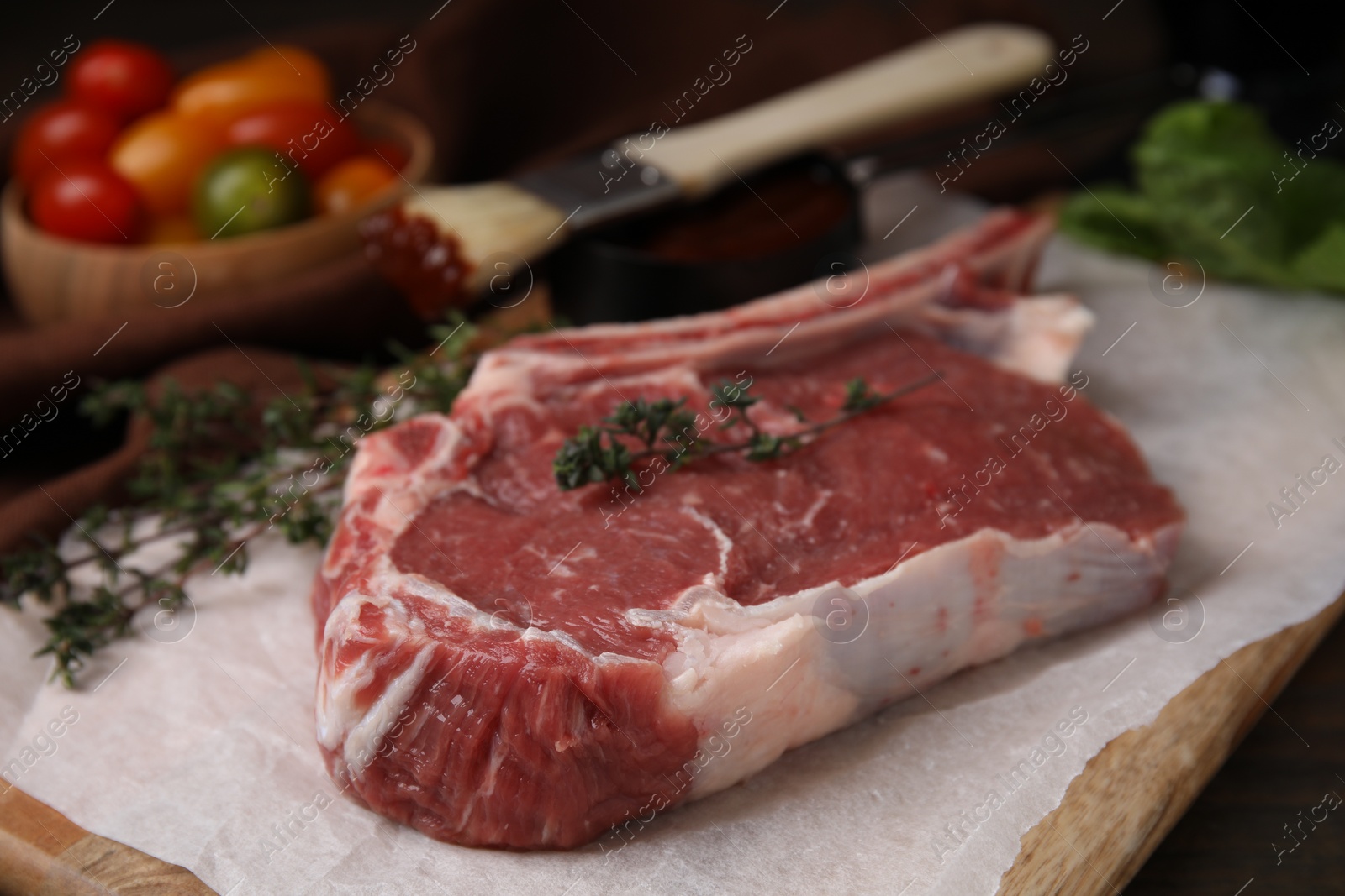 Photo of Raw meat and thyme on table, closeup