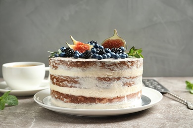 Photo of Delicious homemade cake with fresh berries on table