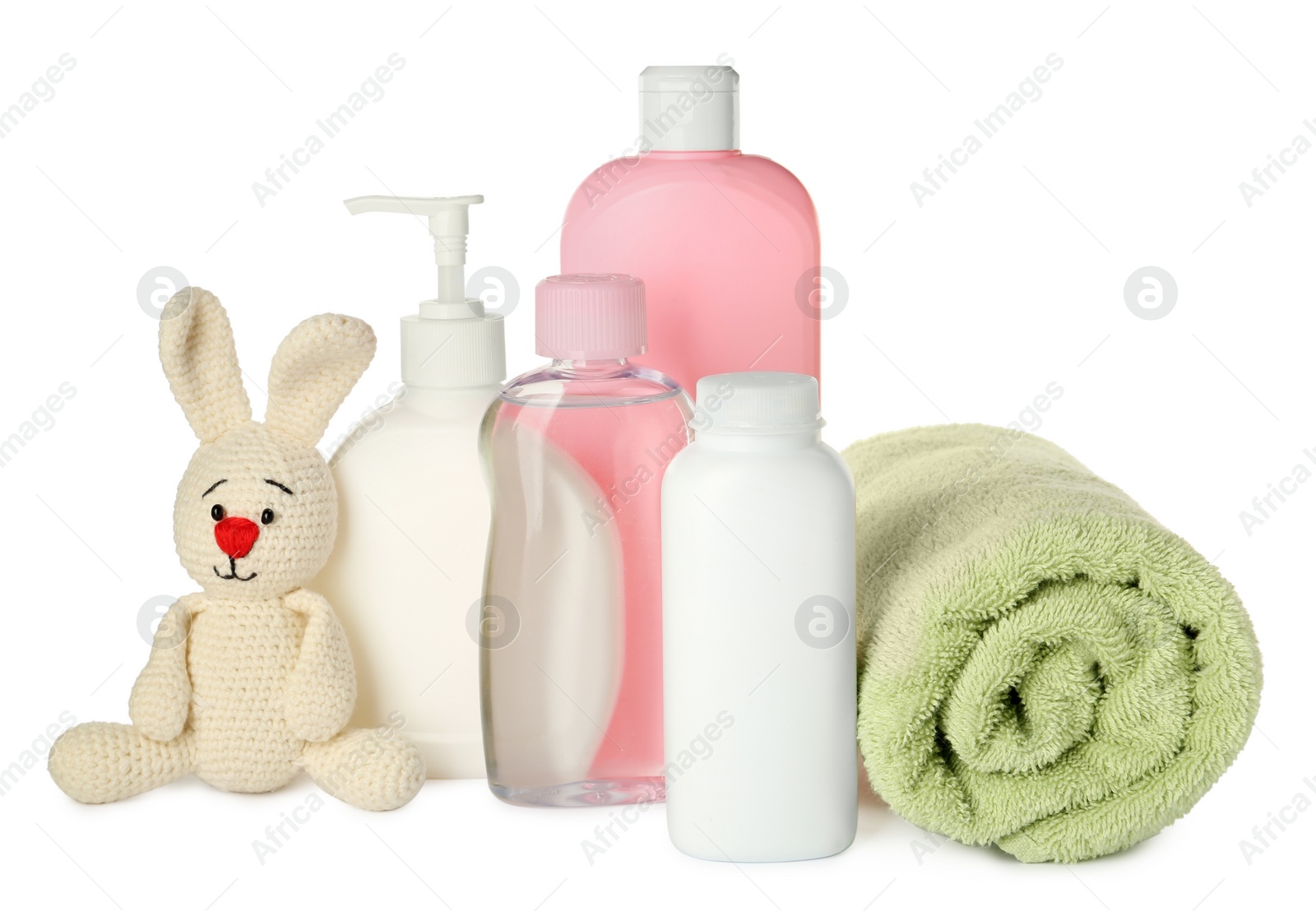 Photo of Bottles of baby cosmetic products, towel and toy bunny on white background