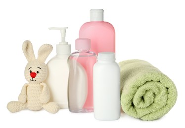 Bottles of baby cosmetic products, towel and toy bunny on white background
