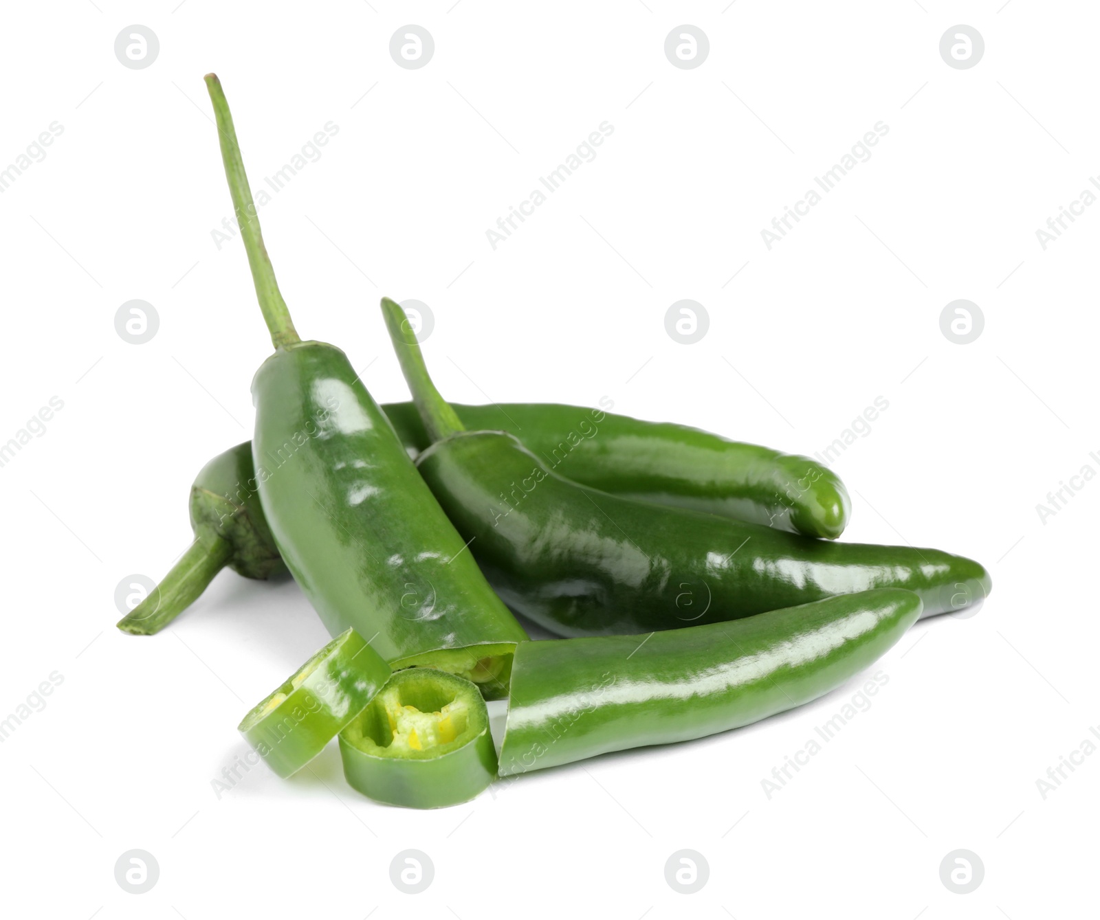 Photo of Cut and whole green hot chili peppers on white background