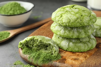 Photo of Tasty matcha cookies and powder on grey table, closeup. Space for text