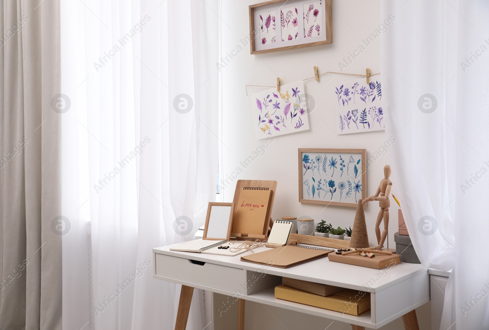 Photo of Stylish room interior with creative workplace near white wall