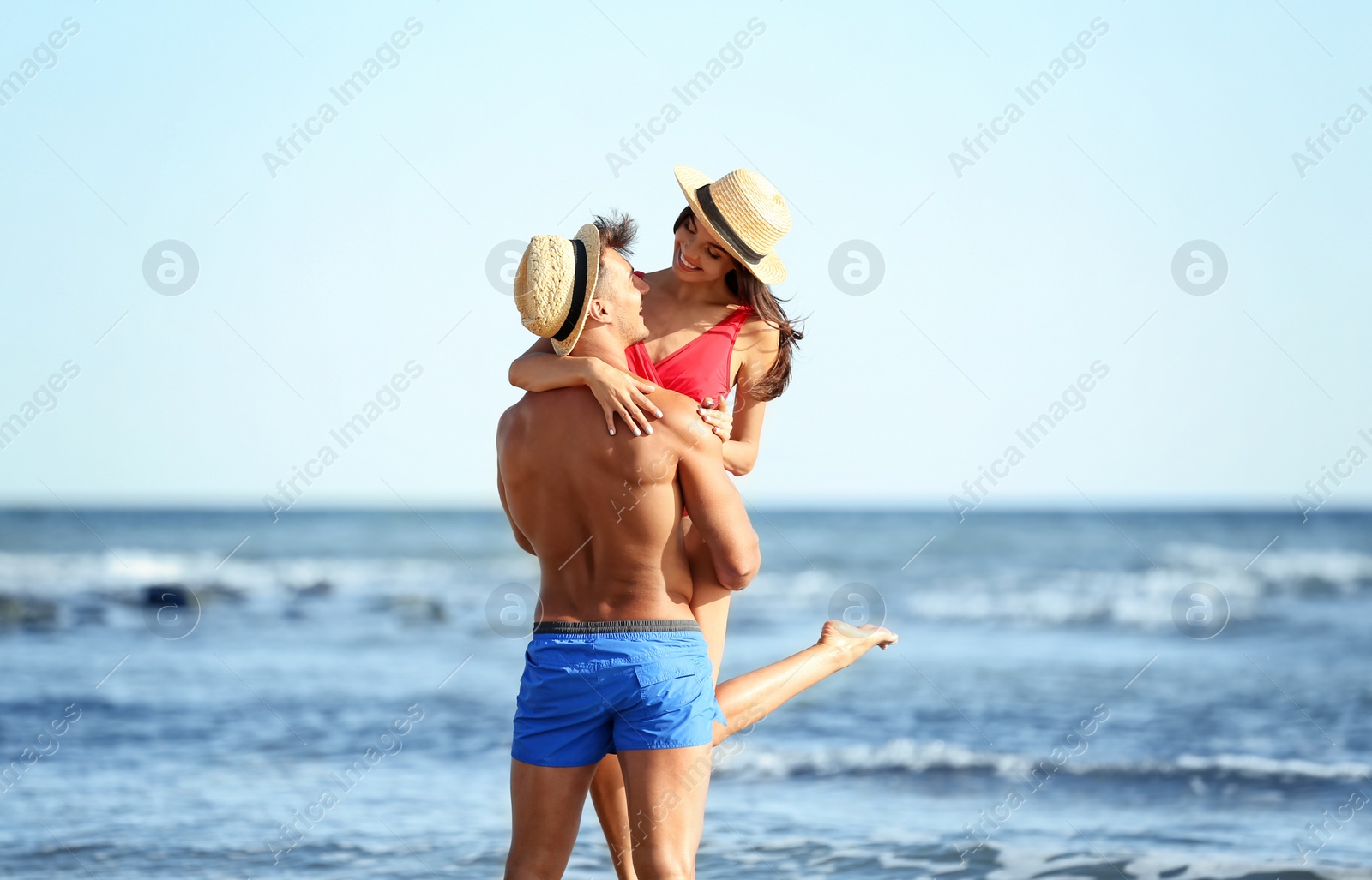 Photo of Happy young couple having fun at beach on sunny day