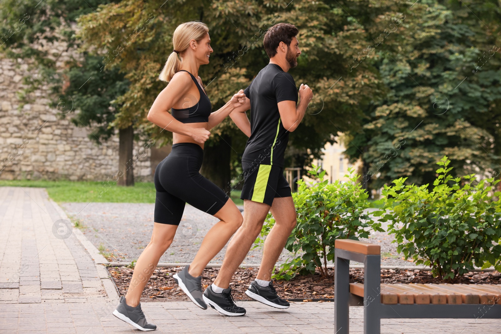 Photo of Healthy lifestyle. Happy couple running in park