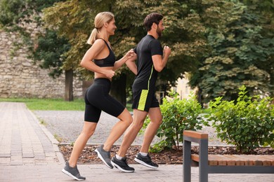 Healthy lifestyle. Happy couple running in park