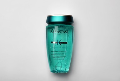 Photo of MYKOLAIV, UKRAINE - SEPTEMBER 07, 2021: Kerastase shampoo on light background, top view. Hair care cosmetic product