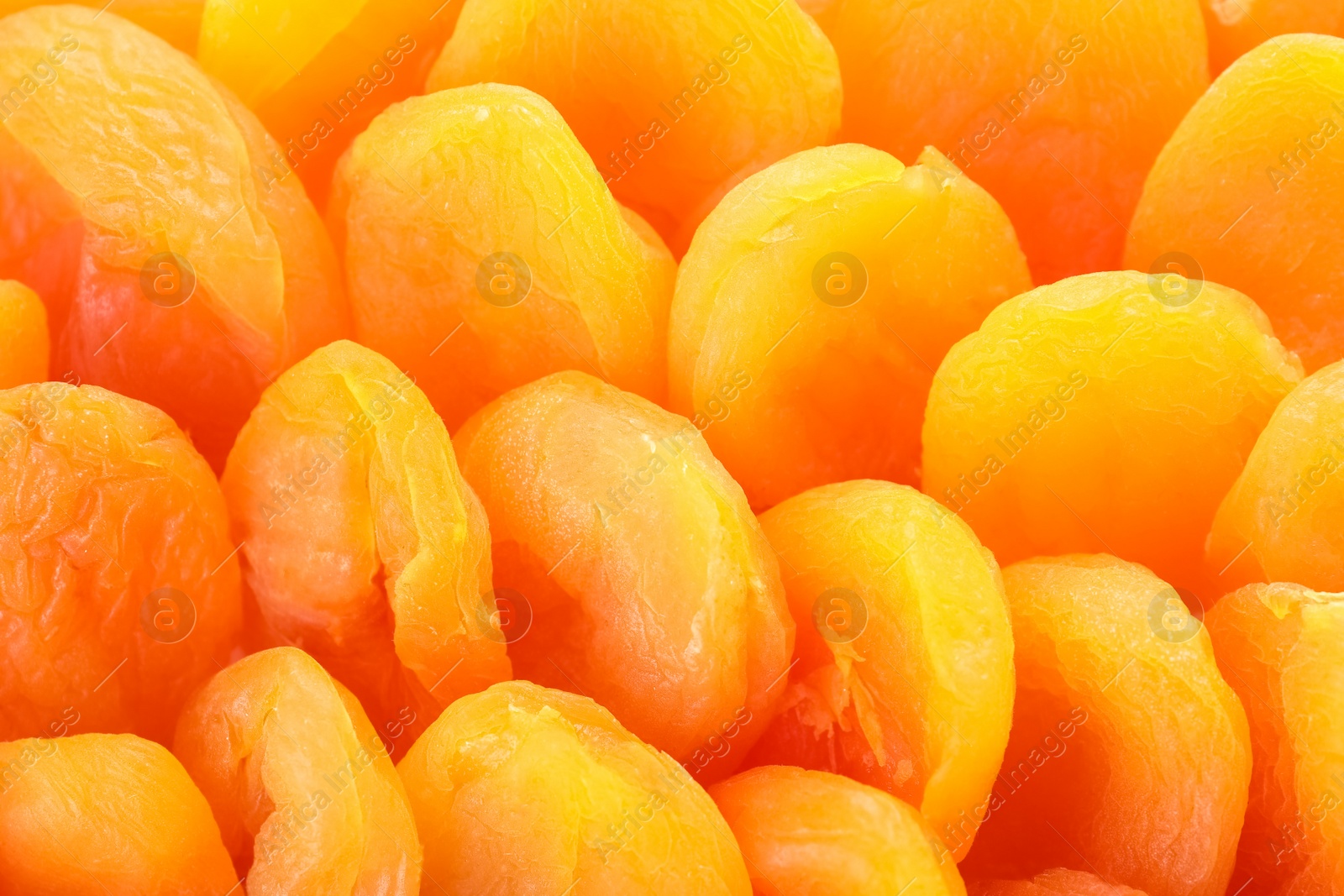 Photo of Tasty apricots as background, closeup. Dried fruit as healthy food