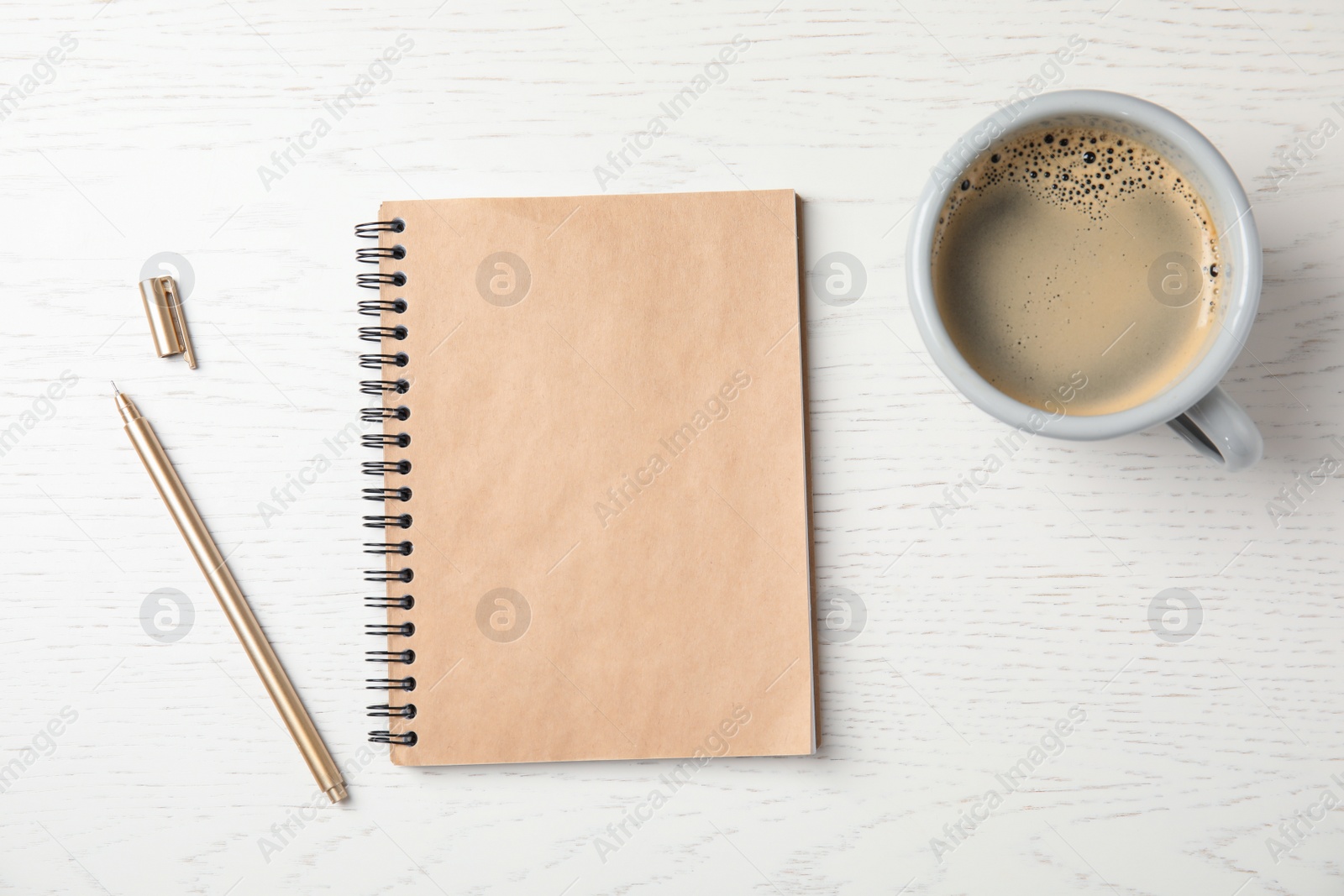 Photo of Notebook and cup of coffee on wooden background, top view