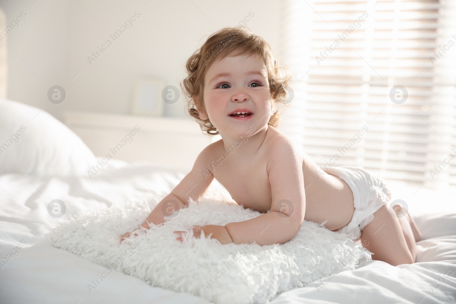 Photo of Cute little baby on bed at home