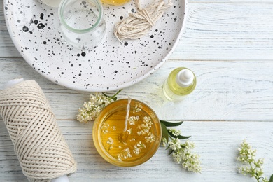 Photo of Flat lay composition with candle on wooden background