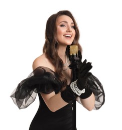 Beautiful young woman in stylish black dress with microphone singing on white background