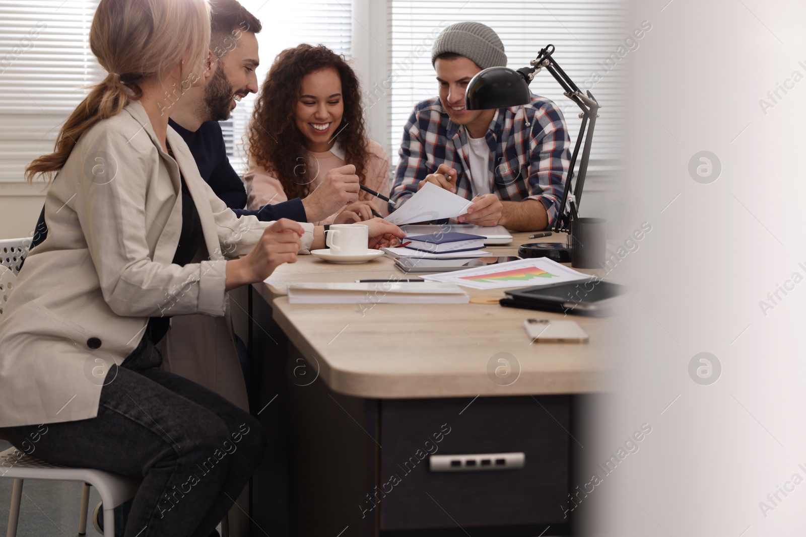 Photo of Team of employees working together in office. Startup project