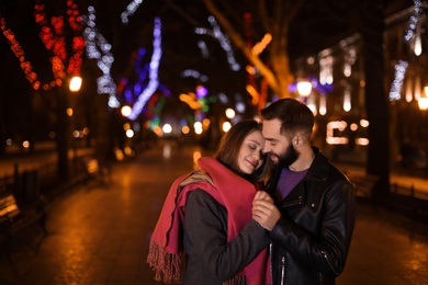 Lovely couple spending time in city at night