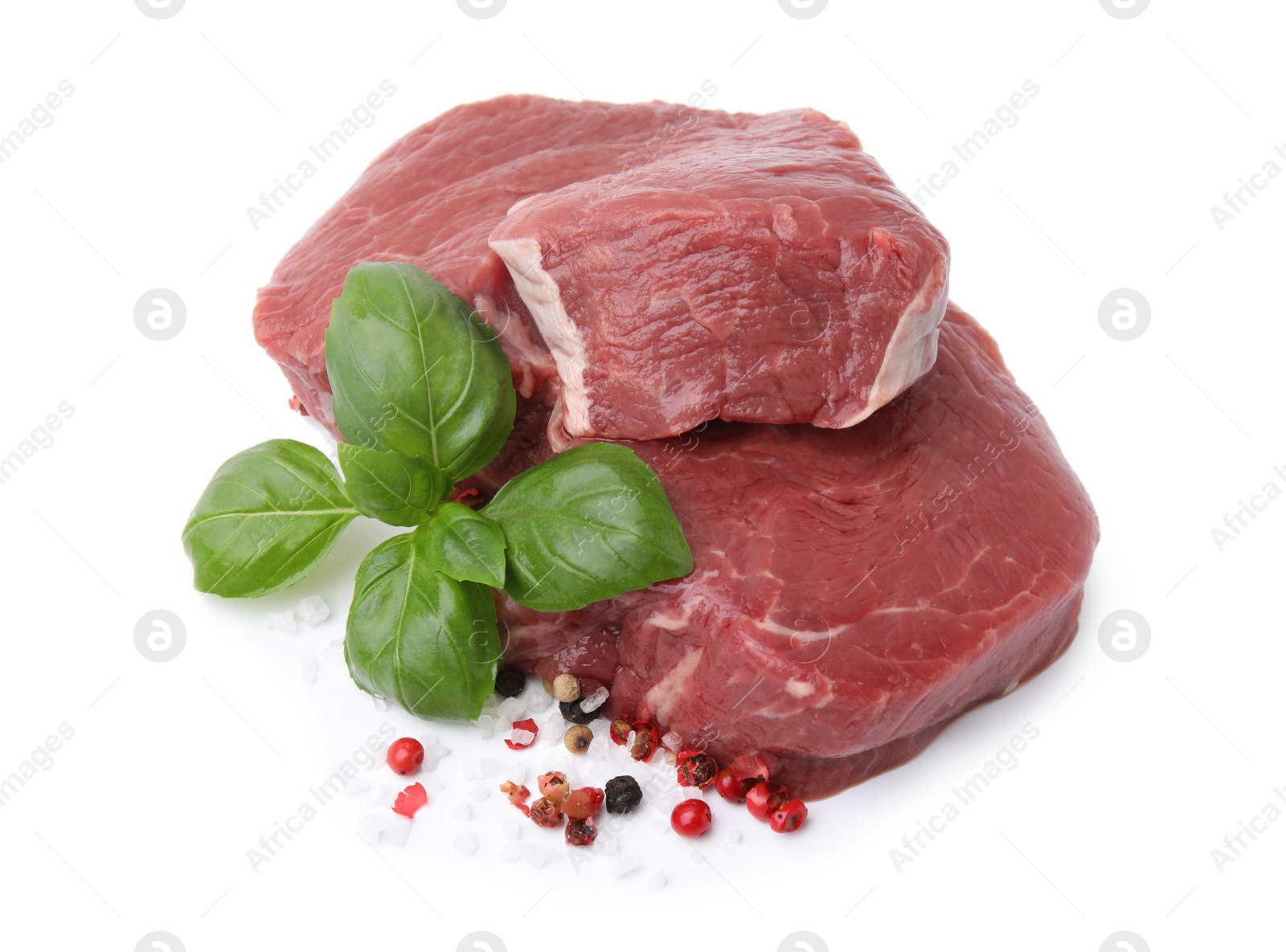 Photo of Fresh beef meat with basil leaves and spices isolated on white