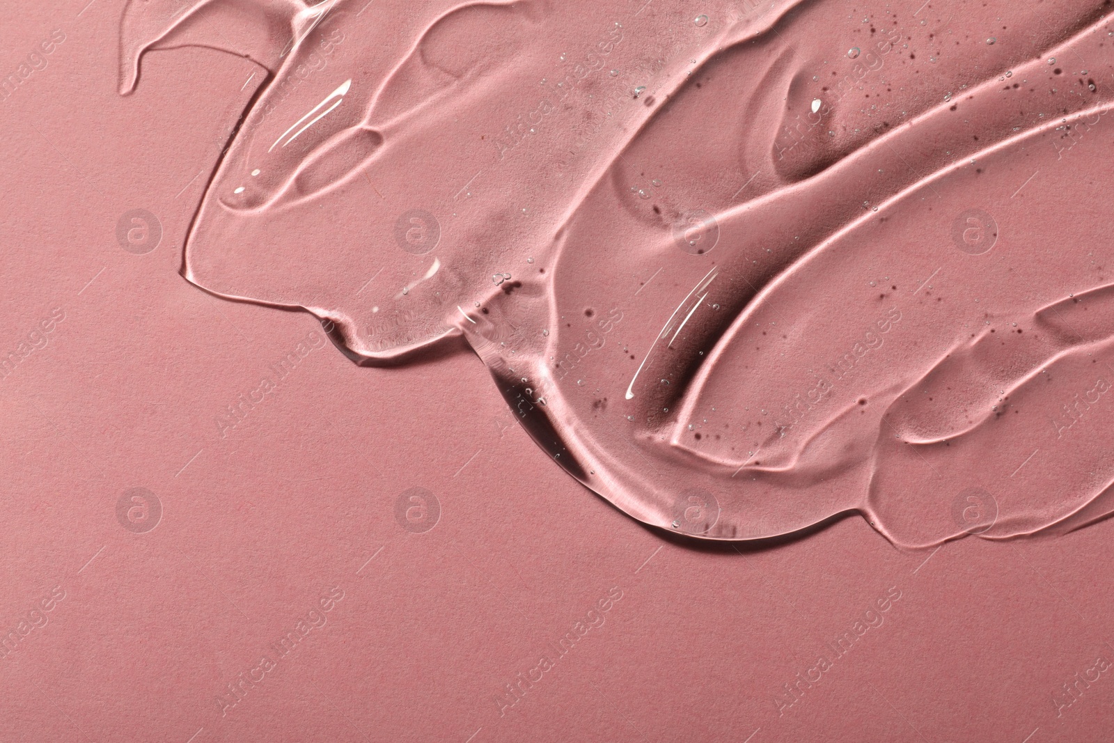 Photo of Transparent cosmetic gel on pink background, space for text