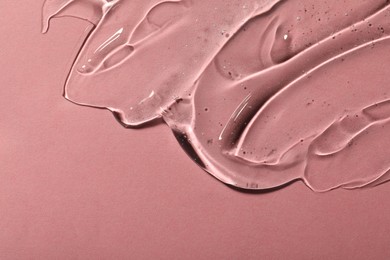 Photo of Transparent cosmetic gel on pink background, space for text