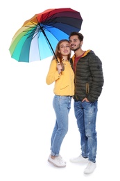 Photo of Young romantic couple with bright umbrella on white background