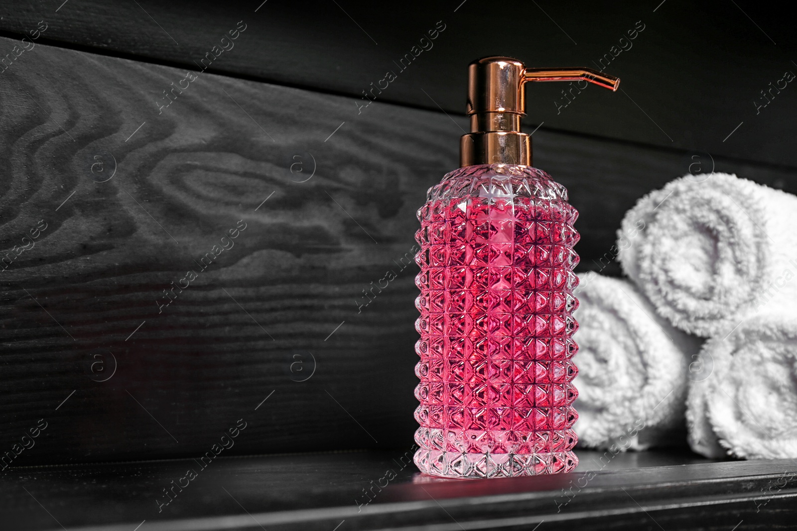 Photo of Soap dispenser and towels on table. Space for text