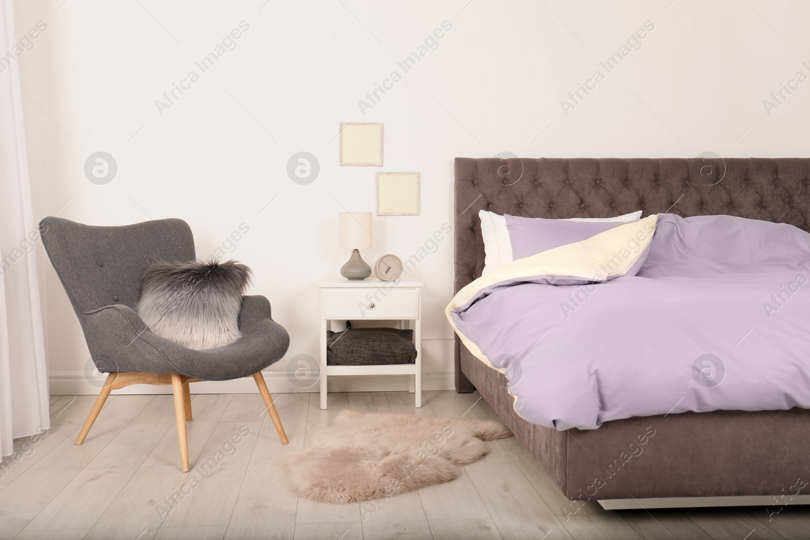 Photo of Modern bedroom interior with comfortable armchair. Stylish design