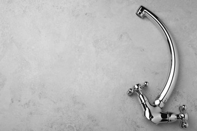 Photo of Double handle water tap on grey table, top view. Space for text