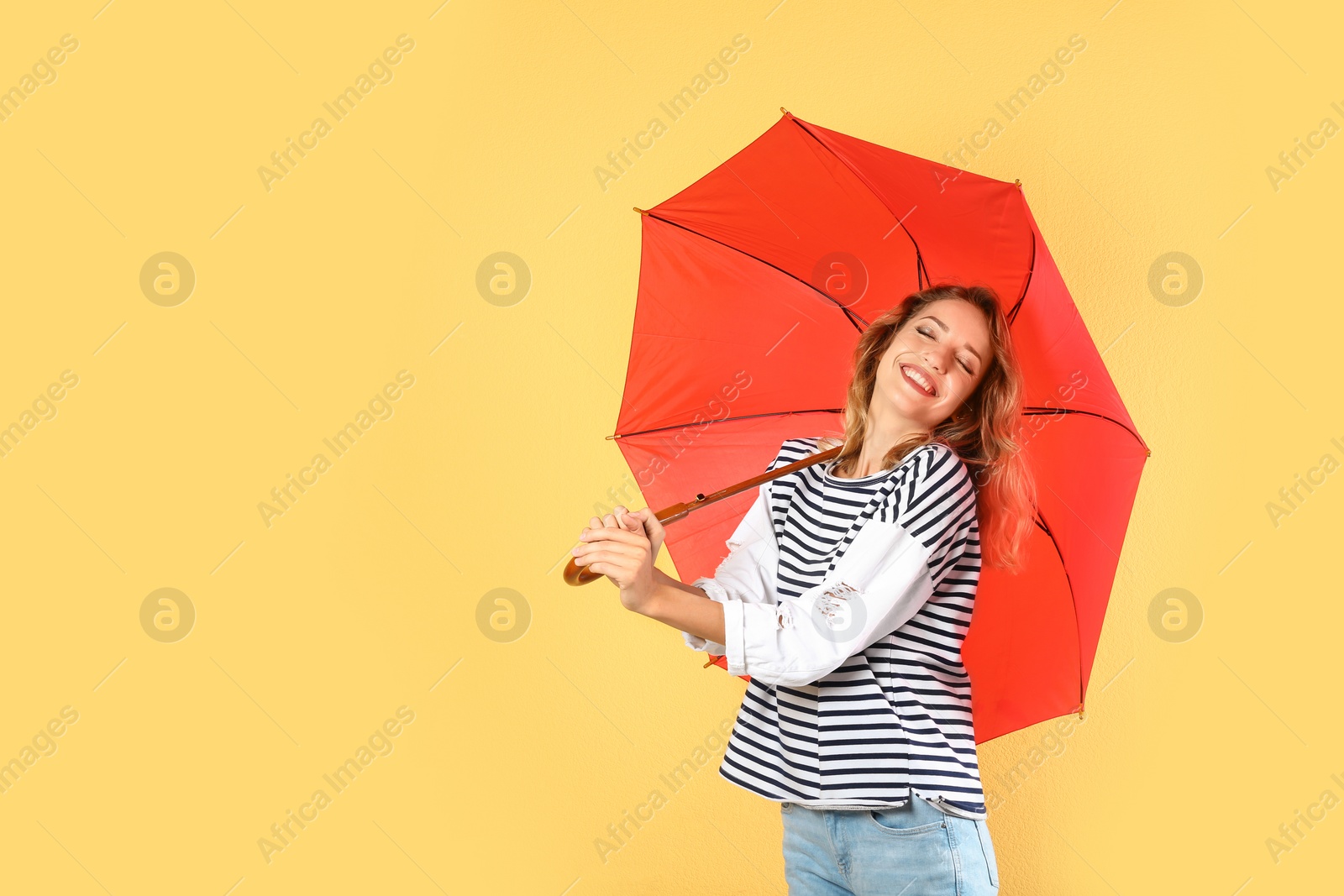 Photo of Woman with red umbrella on color background