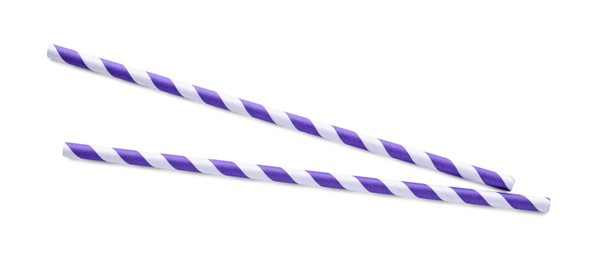 Photo of Striped paper cocktail straws on white background, top view