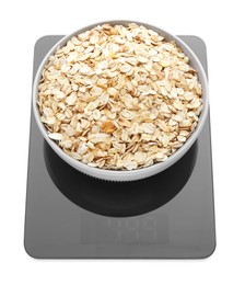 Photo of Modern kitchen scale with bowl of raw oatmeal isolated on white