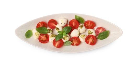 Photo of Plate of tasty Caprese salad with mozzarella, tomatoes, basil and pesto sauce isolated on white, top view